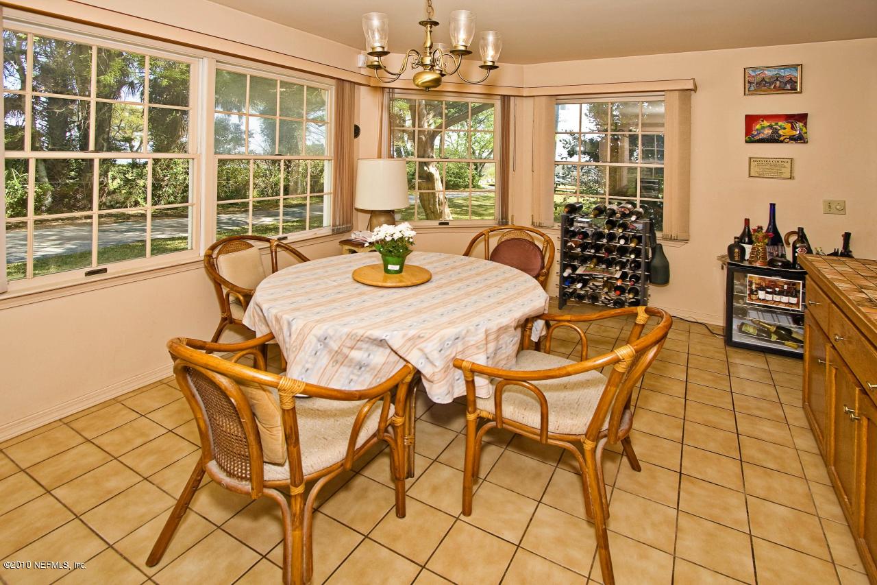84 Water Street St. Augustine, FL 32084 - Photo 13 of 25 a view of a dining room with furniture large windows and wooden floor