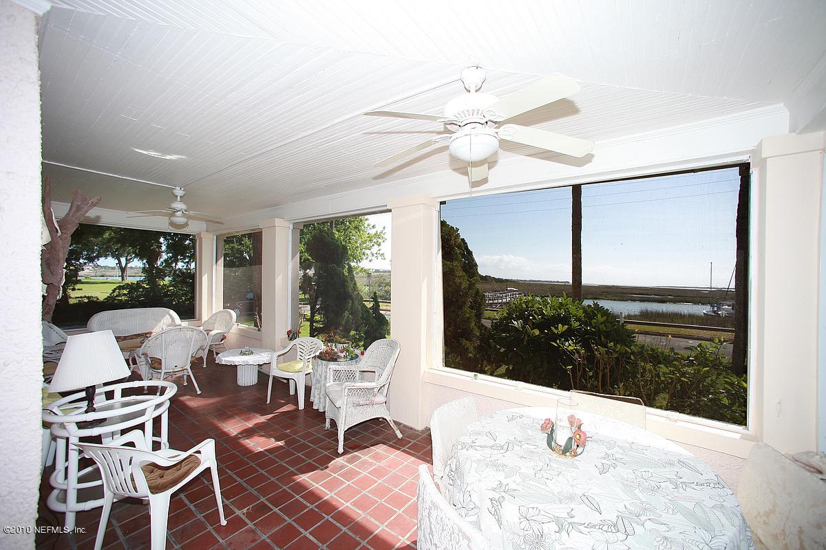 84 Water Street St. Augustine, FL 32084 - Photo 21 of 25 a living room with furniture and a floor to ceiling window