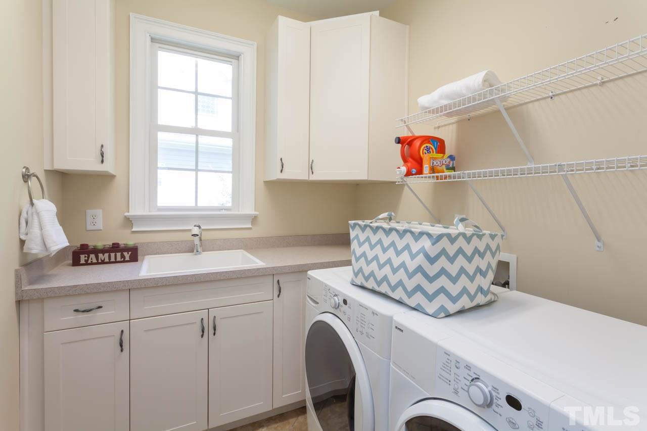8814 Fidelis Lane Raleigh, NC 27613 - Photo 12 of 25 Fabulous utility room with cabinets and counters for many uses.