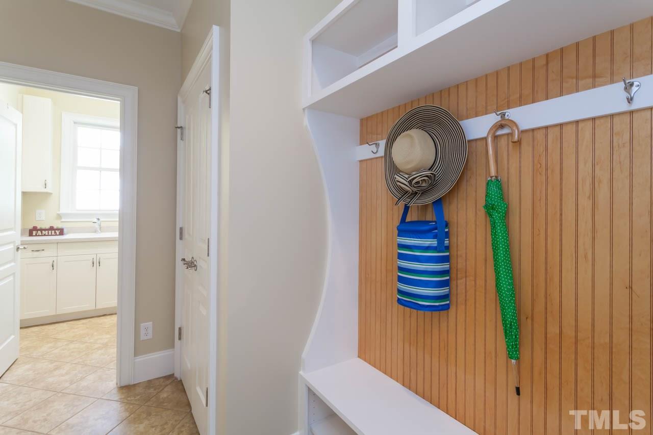 8814 Fidelis Lane Raleigh, NC 27613 - Photo 13 of 25 Another one of the great custom detail features of the home. Excellent area for bookbags, shoes, etc. and located just off the laundry room.