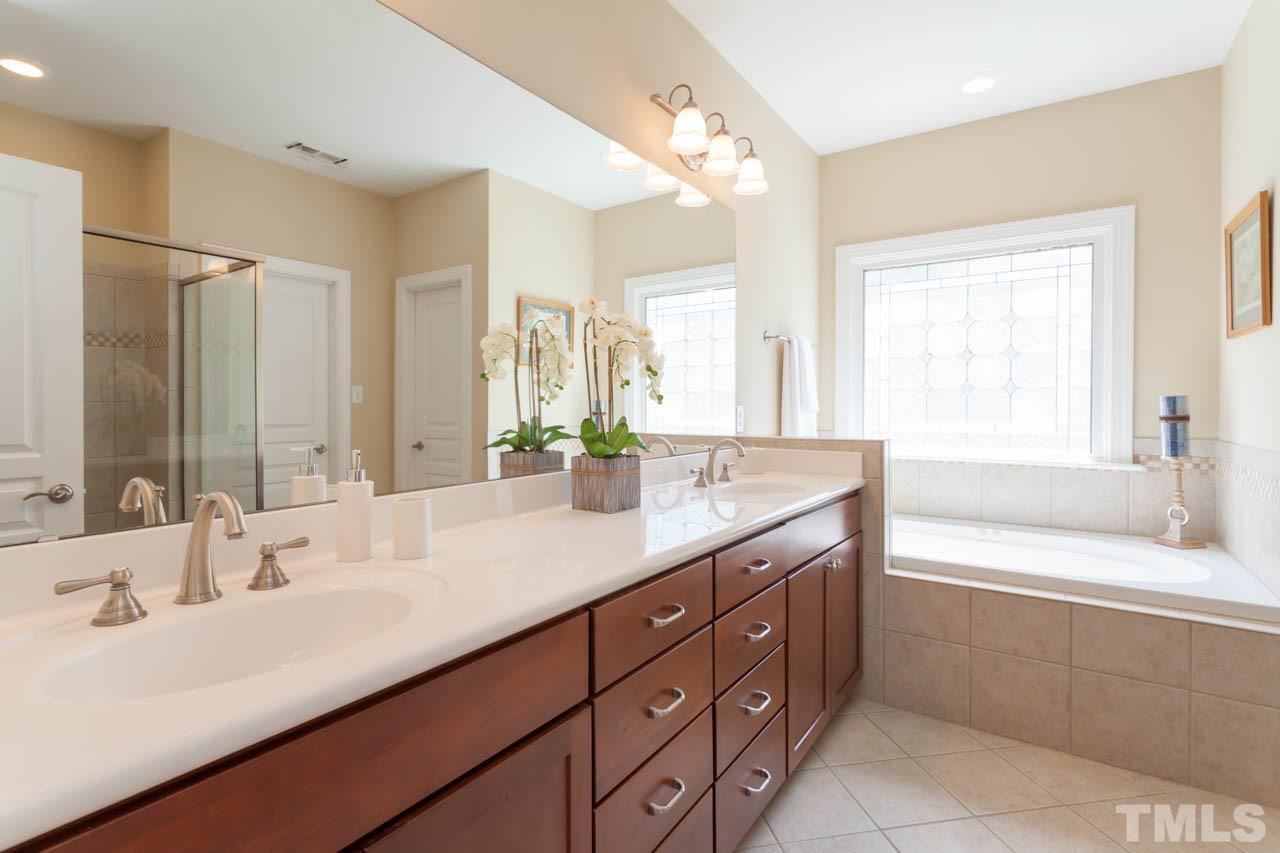 8814 Fidelis Lane Raleigh, NC 27613 - Photo 15 of 25 Custom Master Bath with dual vanity, garden tub and walk-in shower.