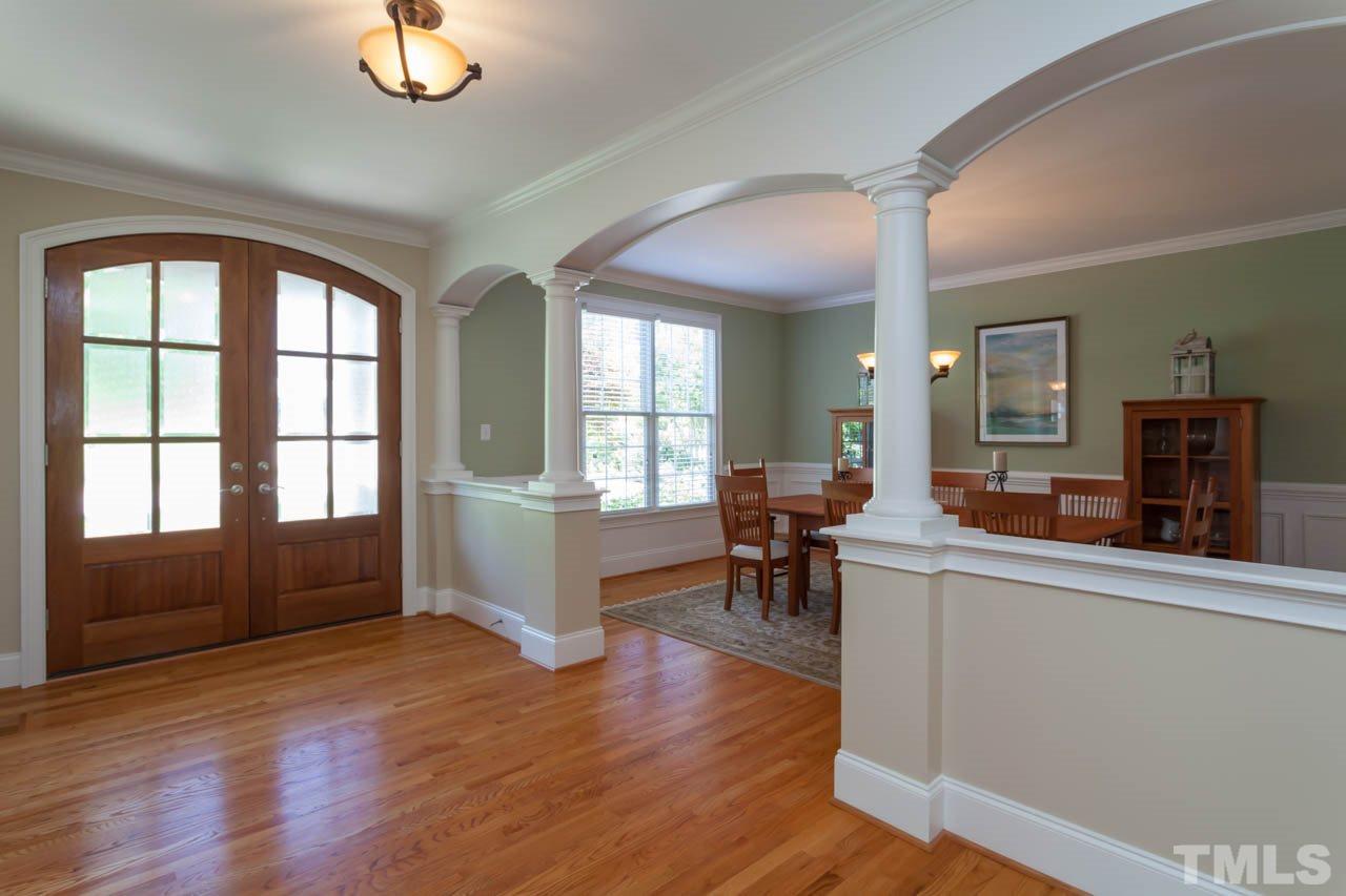 8814 Fidelis Lane Raleigh, NC 27613 - Photo 3 of 25 Welcome guests in this exquisite foyer with beautiful custom doors and hardwoods through most of first floor.