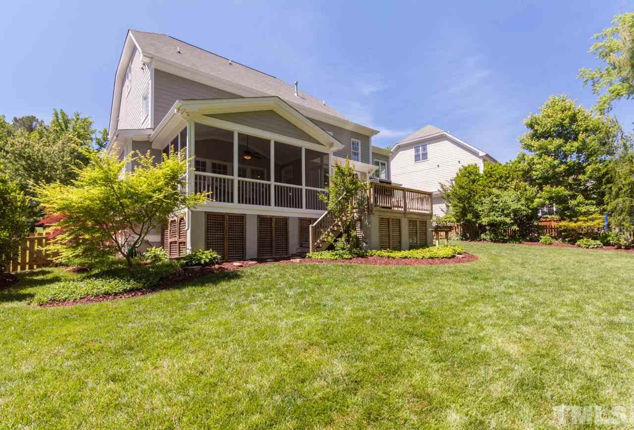 8814 Fidelis Lane Raleigh, NC 27613 - Photo 22 of 25 Beautiful view of the rear of the home with Screeened Porch and Deck. Lush landscaping adds to the beauty.