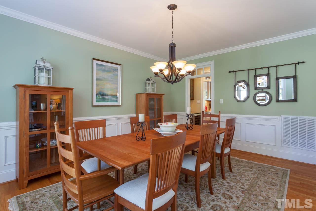 8814 Fidelis Lane Raleigh, NC 27613 - Photo 5 of 25 Enjoy an intimate meal or entertain guests in this intricately detailed Dining Room adorned with chair and crown moldings and glowing hardwoods.