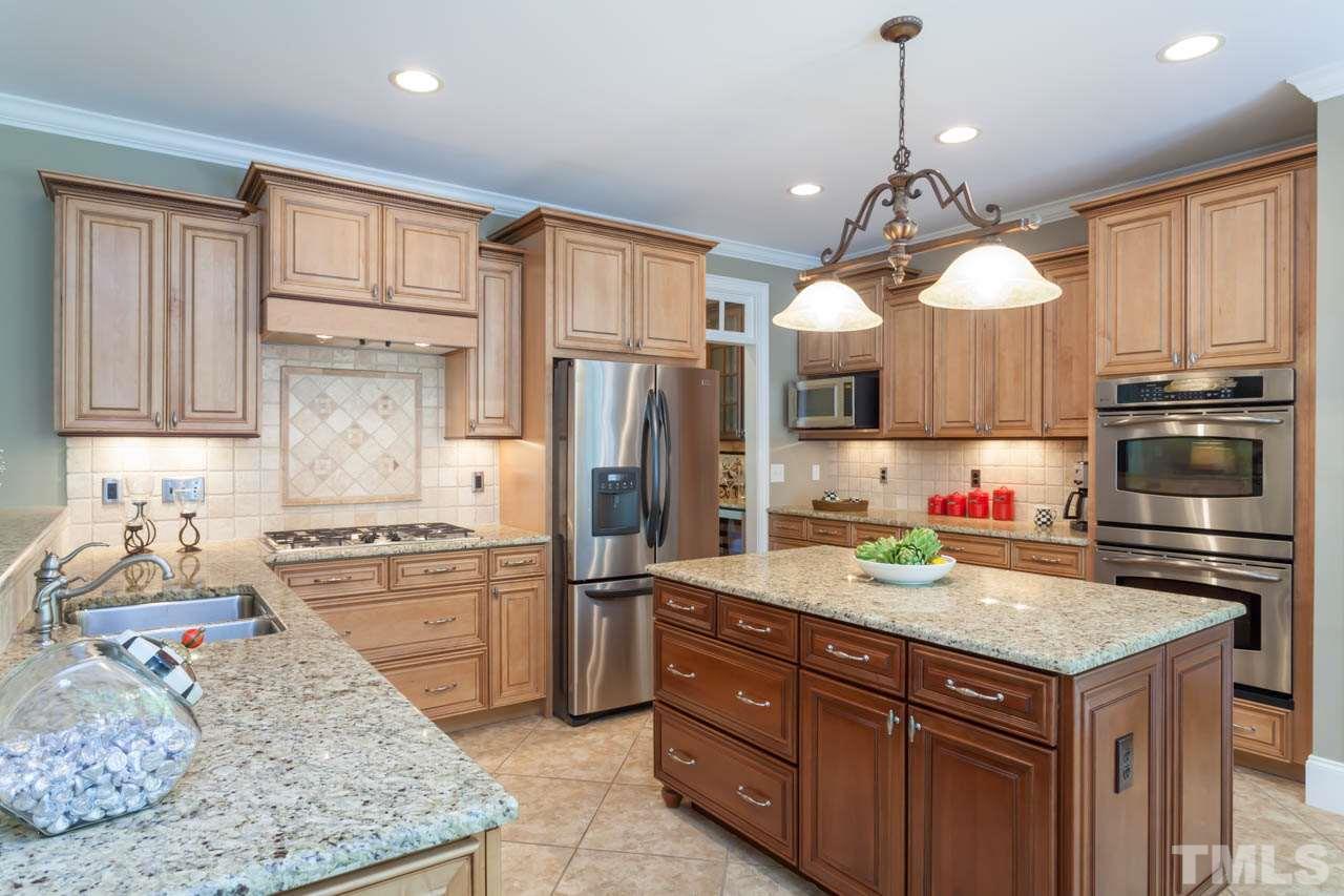8814 Fidelis Lane Raleigh, NC 27613 - Photo 7 of 25 Gourmet Kitchen with granite countertops, center island and stainless appliances.