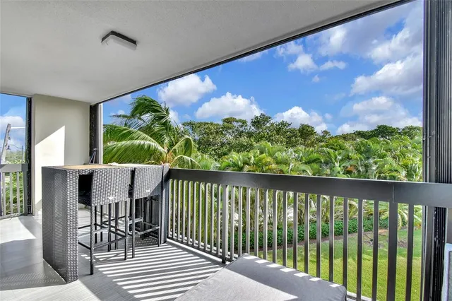 a kitchen with stainless steel appliances granite countertop a sink refrigerator and microwave