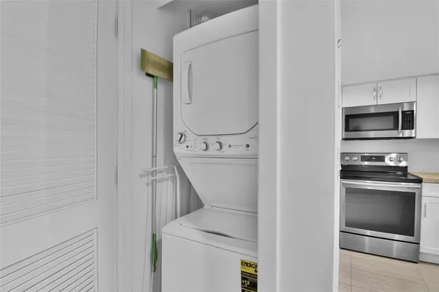 a bedroom with a bed and a dresser next to a window