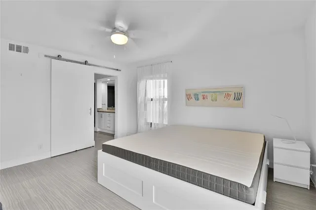 a bathroom with a granite countertop sink a mirror and shower