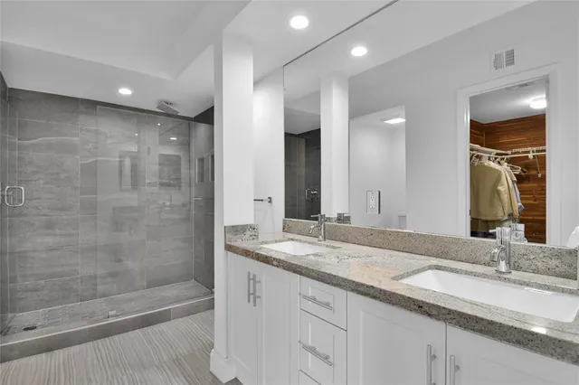 a bathroom with a granite countertop sink mirror and