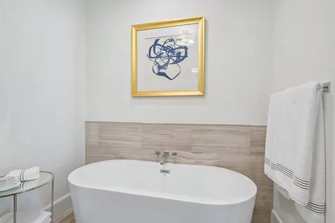a white bath tub sitting next to a white toilet