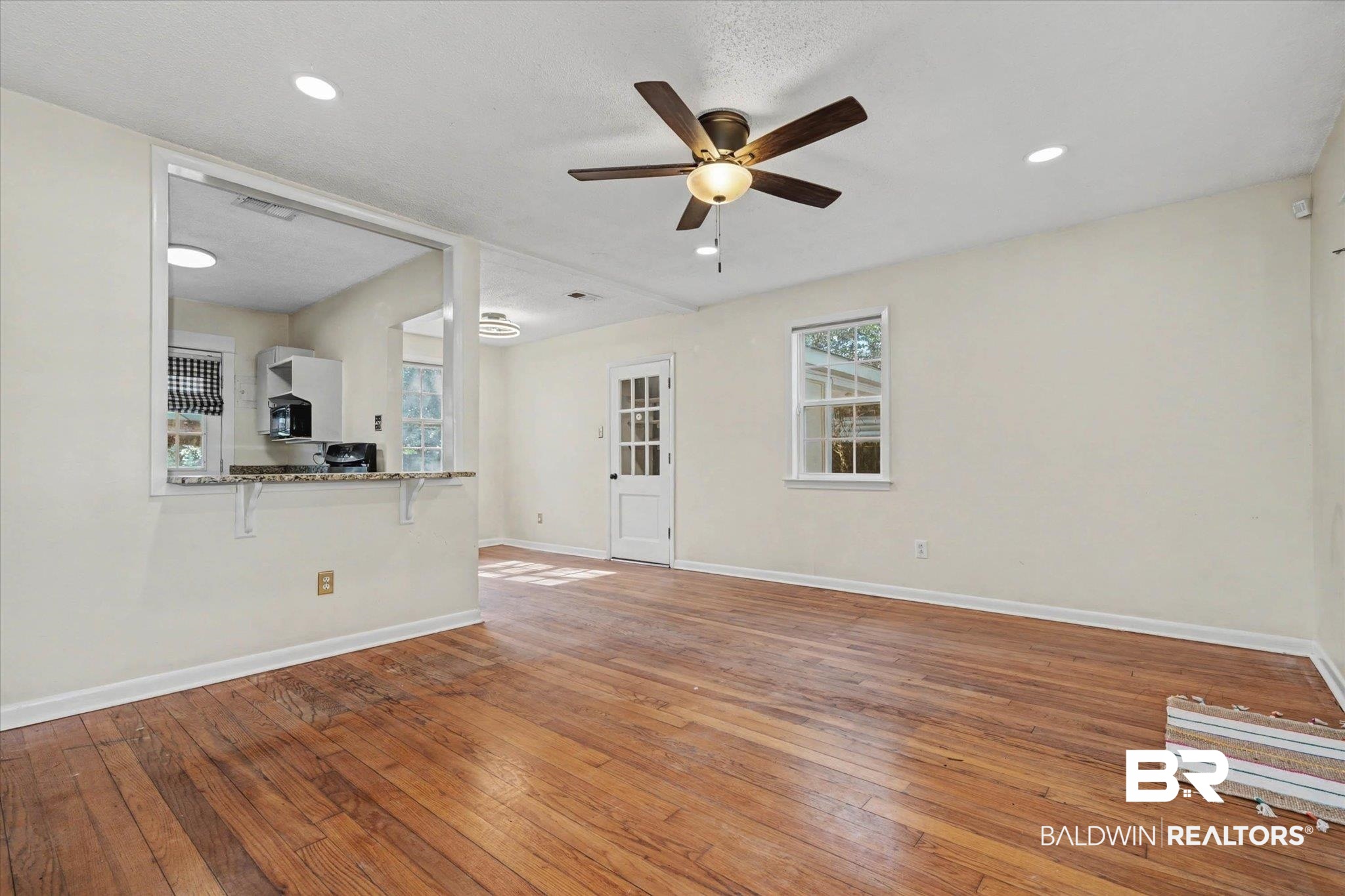 5117 Norton Lane Mobile, AL 36608 - Photo 9 of 35 Unfurnished living room featuring light wood-style flooring and ceiling fan