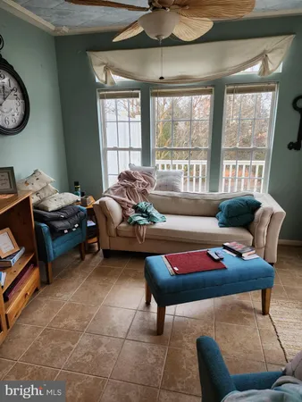 a living room with furniture a rug and a window