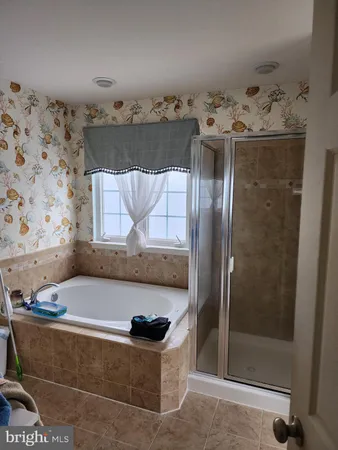 a bathroom with a tub and shower