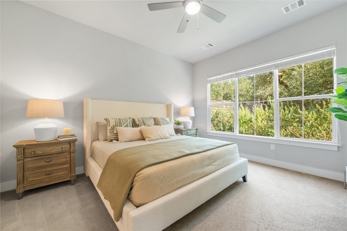 11112 Zimmerman Lane, Unit 24 Austin, TX 78726 - Photo 13 of 29 a bed sitting in a bedroom next to a window