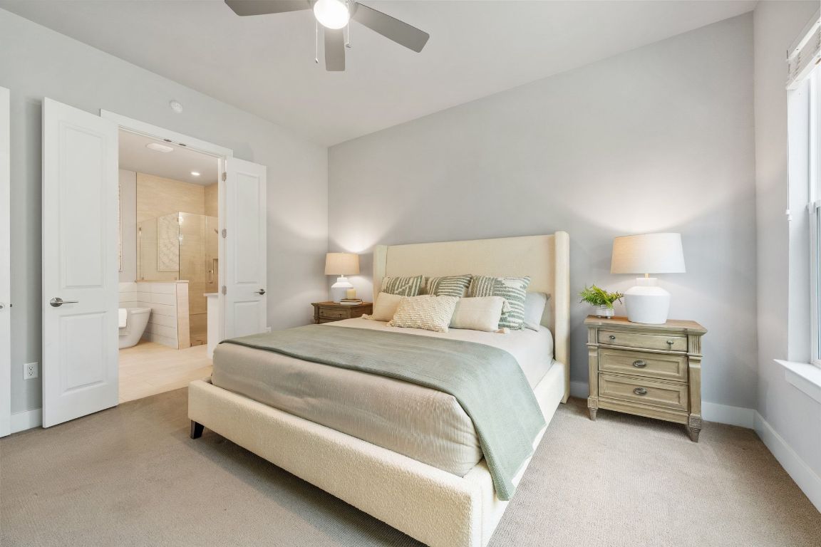 11112 Zimmerman Lane, Unit 24 Austin, TX 78726 - Photo 14 of 29 a spacious bedroom with a bed and a chandelier