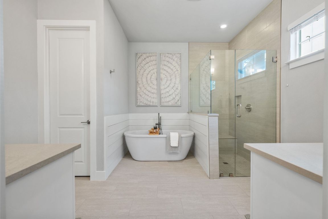 11112 Zimmerman Lane, Unit 24 Austin, TX 78726 - Photo 16 of 29 a bathroom with a bathtub sink mirror and toilet