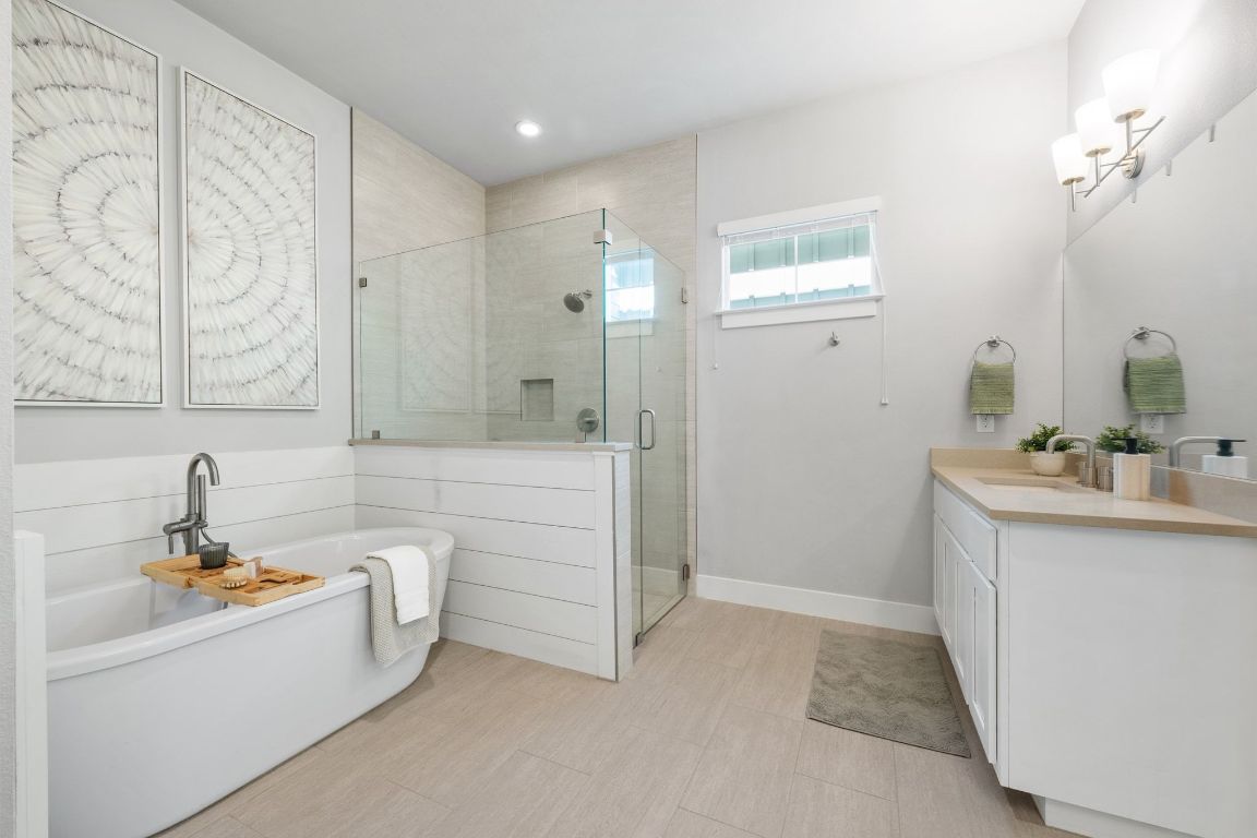11112 Zimmerman Lane, Unit 24 Austin, TX 78726 - Photo 17 of 29 a bathroom with a sink a mirror and a bathtub