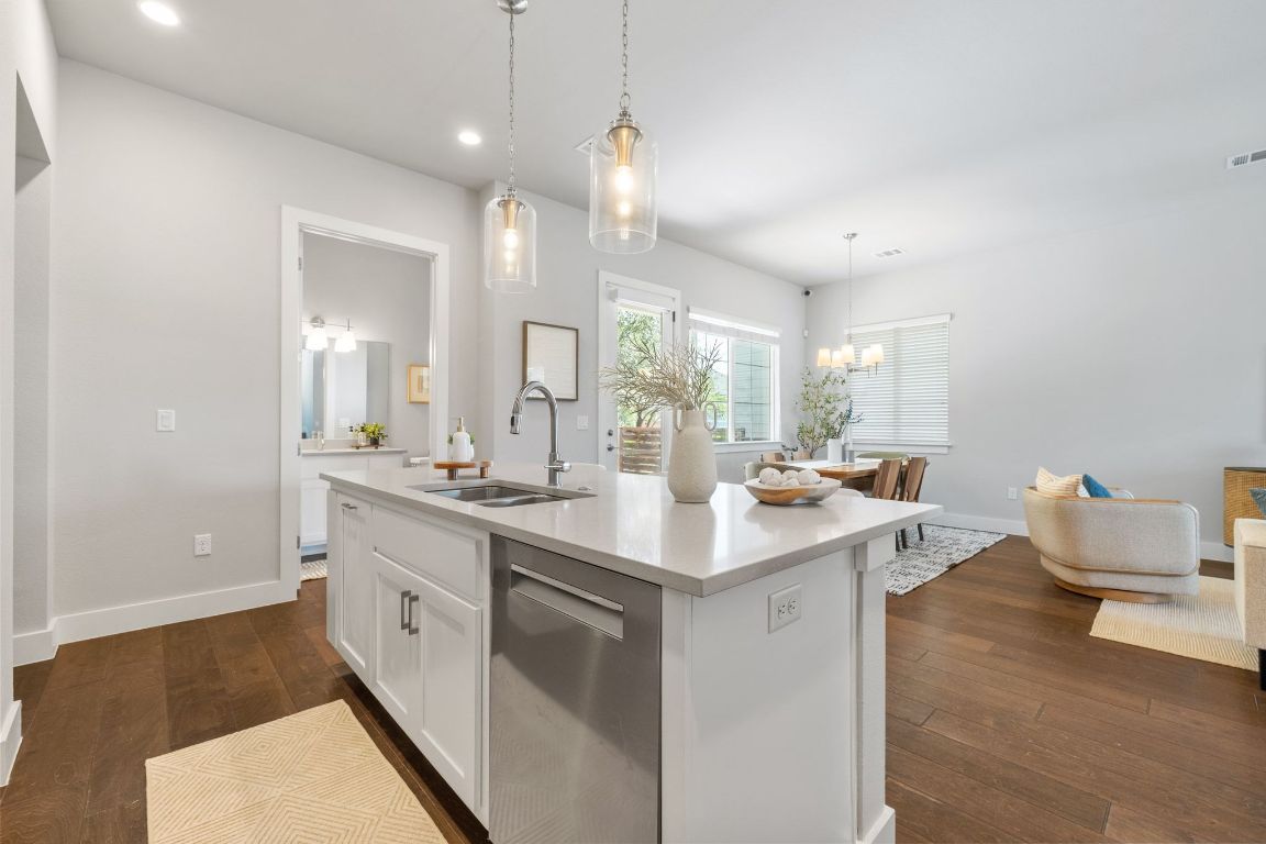 11112 Zimmerman Lane, Unit 24 Austin, TX 78726 - Photo 3 of 29 a kitchen with sink cabinets and wooden floor