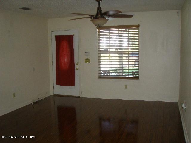 2070 Benedict Road Jacksonville, FL 32209 - Photo 15 of 38 a view of an empty room with wooden floor and a window
