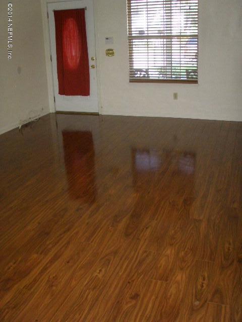 2070 Benedict Road Jacksonville, FL 32209 - Photo 16 of 38 an empty room with wooden floor and windows