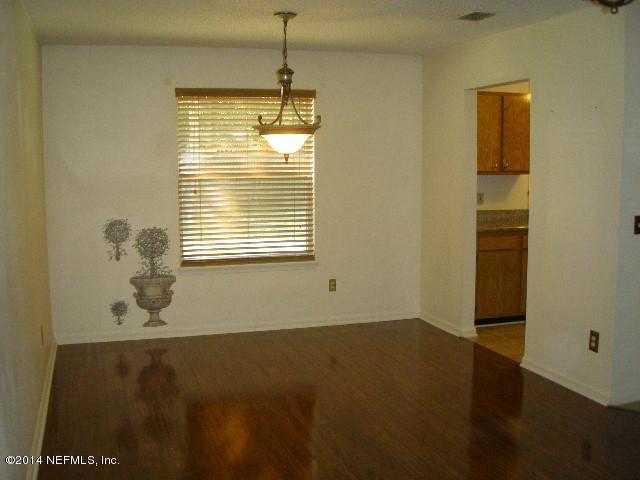 2070 Benedict Road Jacksonville, FL 32209 - Photo 18 of 38 a view of an empty room with wooden floor and a window