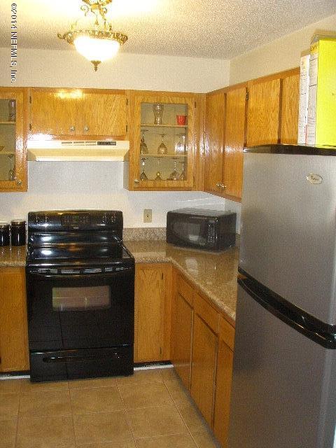 2070 Benedict Road Jacksonville, FL 32209 - Photo 22 of 38 a kitchen with stainless steel appliances a stove and a refrigerator