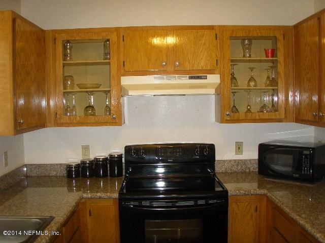 2070 Benedict Road Jacksonville, FL 32209 - Photo 23 of 38 a kitchen with stainless steel appliances granite countertop a stove and a microwave