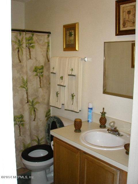 2070 Benedict Road Jacksonville, FL 32209 - Photo 24 of 38 a bathroom with a sink a toilet and a mirror