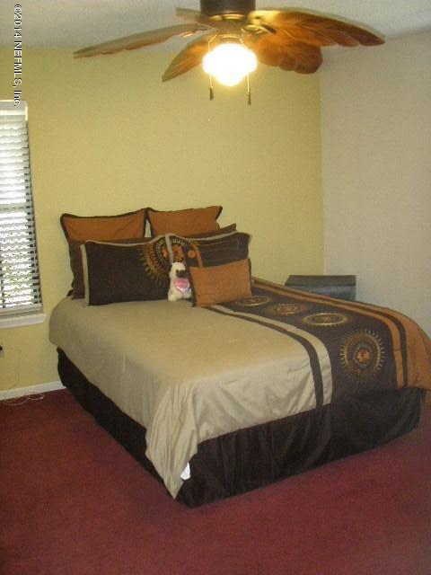 2070 Benedict Road Jacksonville, FL 32209 - Photo 31 of 38 a bedroom with a bed and chandelier