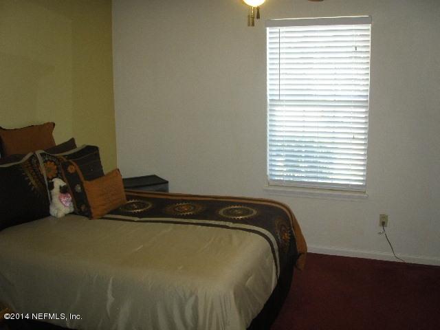 2070 Benedict Road Jacksonville, FL 32209 - Photo 33 of 38 a bed sitting in a bedroom next to a window