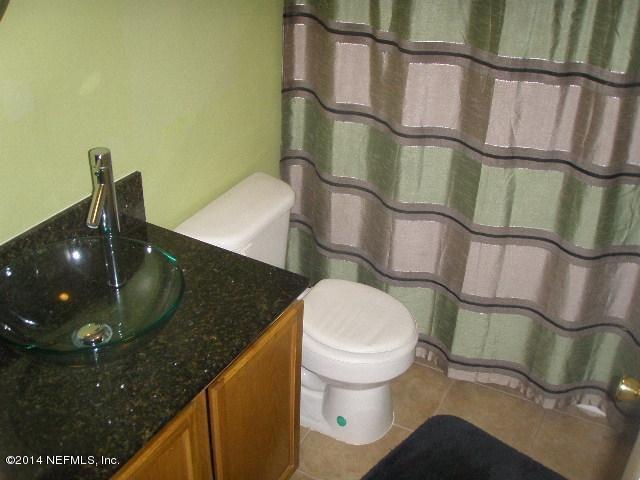 2070 Benedict Road Jacksonville, FL 32209 - Photo 35 of 38 a bathroom with a granite countertop sink and a mirror