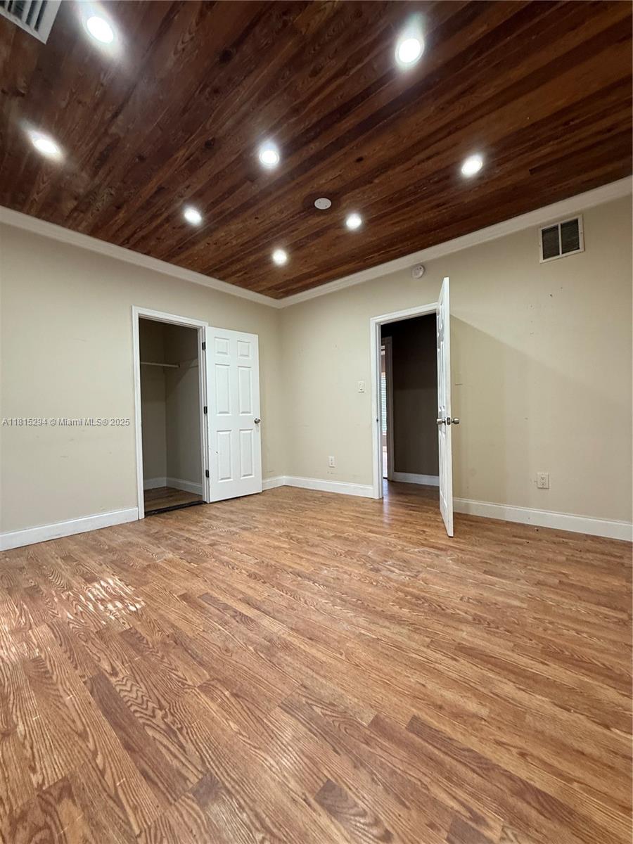 213 Stirling Road Dania Beach, FL 33004 - Photo 4 of 12 a view of an empty room with wooden floor