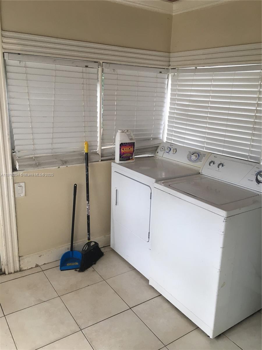 213 Stirling Road Dania Beach, FL 33004 - Photo 9 of 12 a view of a kitchen with a sink and a window