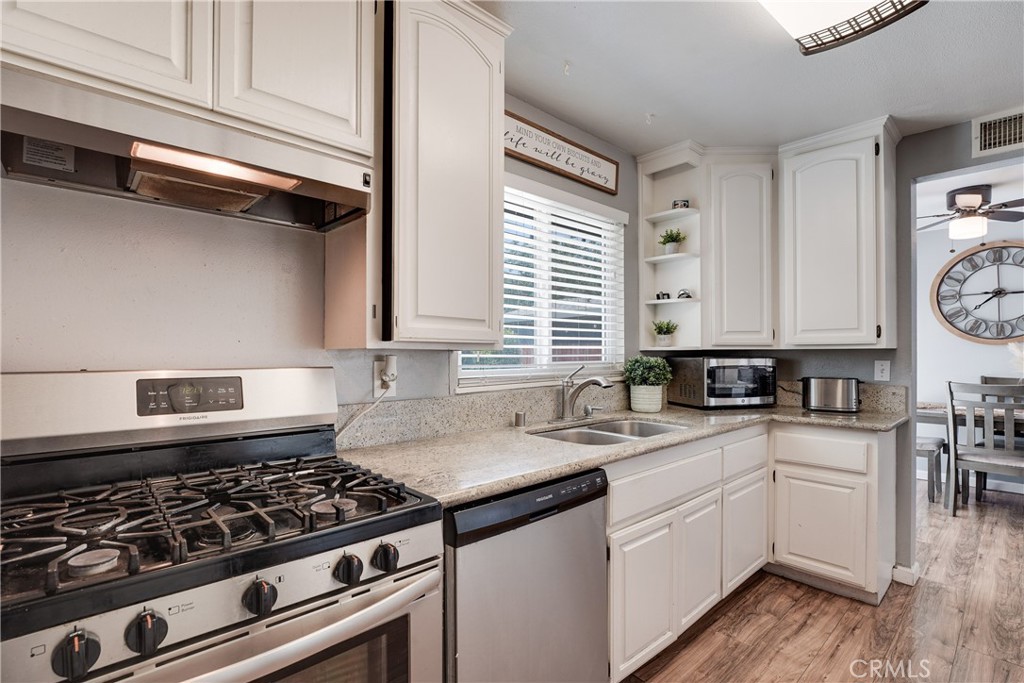 5734 Mountain View Avenue Riverside, CA 92504 - Photo 11 of 28 a kitchen with a sink stove top oven and cabinets
