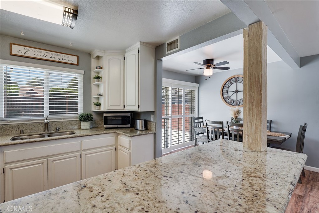 5734 Mountain View Avenue Riverside, CA 92504 - Photo 13 of 28 a kitchen with stainless steel appliances a sink stove and cabinets