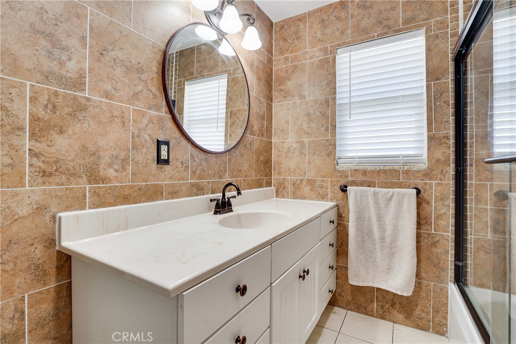 5734 Mountain View Avenue Riverside, CA 92504 - Photo 17 of 28 a bathroom with a sink and a mirror
