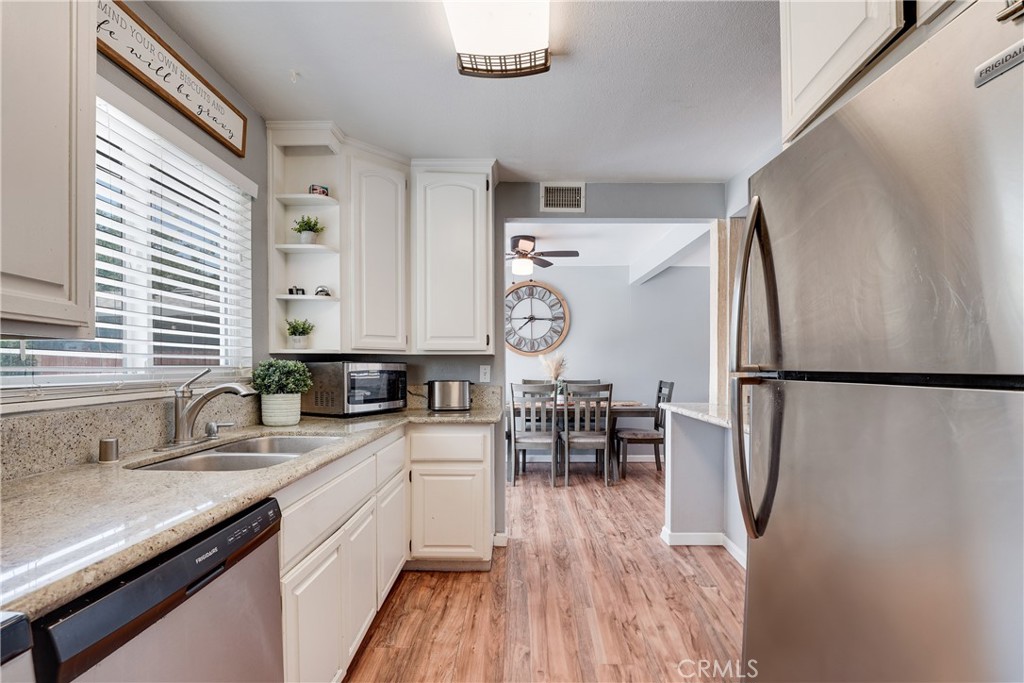 5734 Mountain View Avenue Riverside, CA 92504 - Photo 10 of 28 a kitchen with granite countertop a refrigerator and a sink