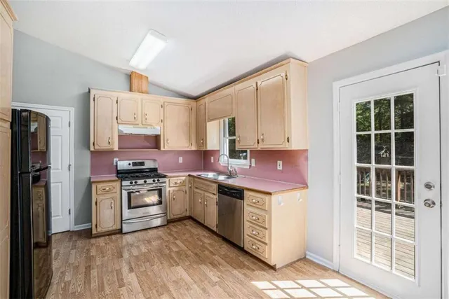 a kitchen with a stove a sink and a refrigerator