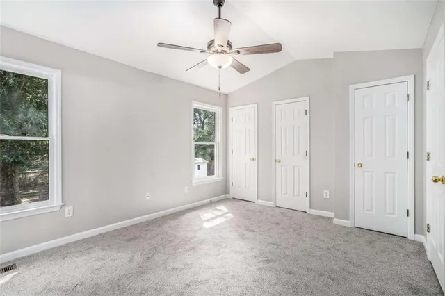 a view of a chandelier fan and window in a room