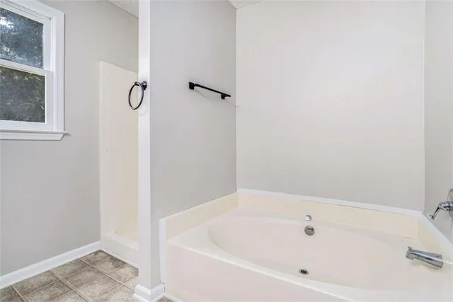 a white bath tub sitting next to a white sink