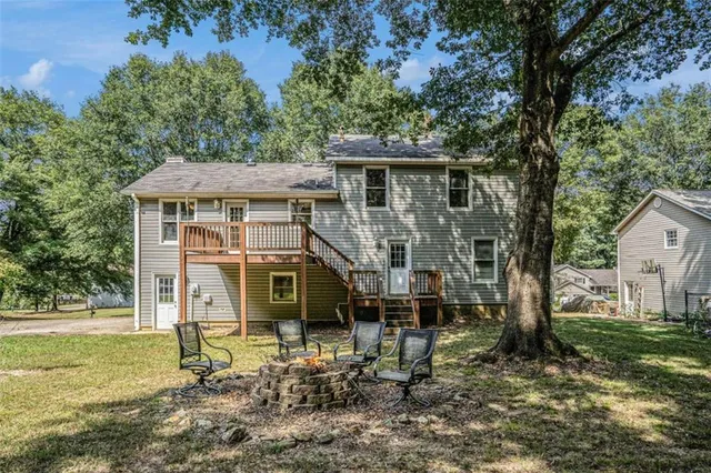 a backyard of a house with barbeque oven table and chairs