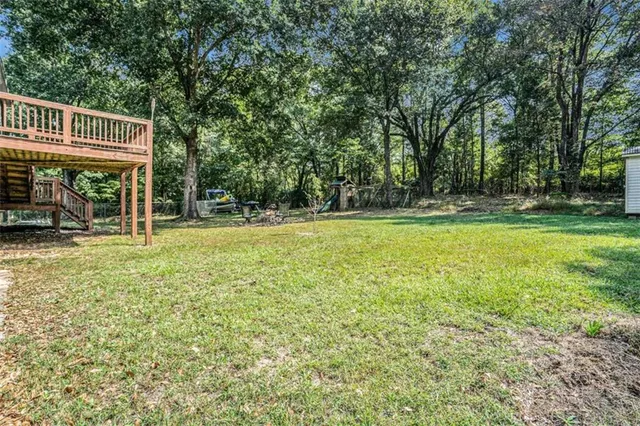 a view of a swimming pool and trees in the background