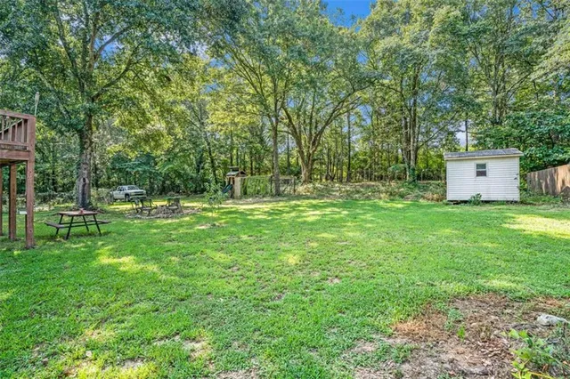 a backyard of a house with lots of green space and fountain