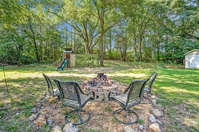 a view of a swimming pool with a table and chairs