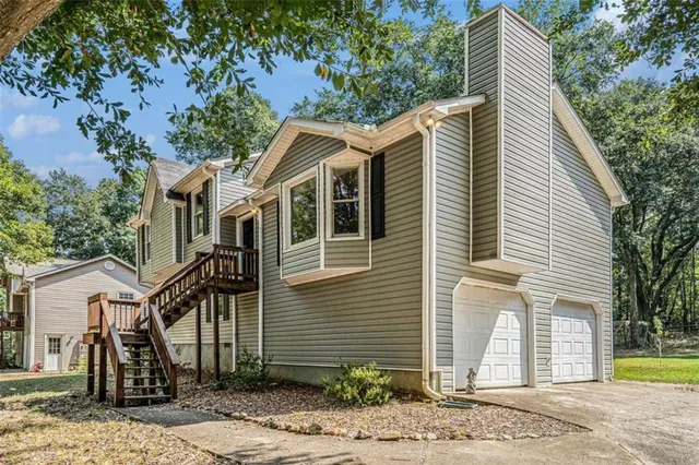 a front view of a house with a garden