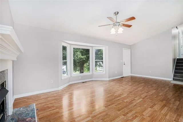 a view of a livingroom with a window and a ceiling fan