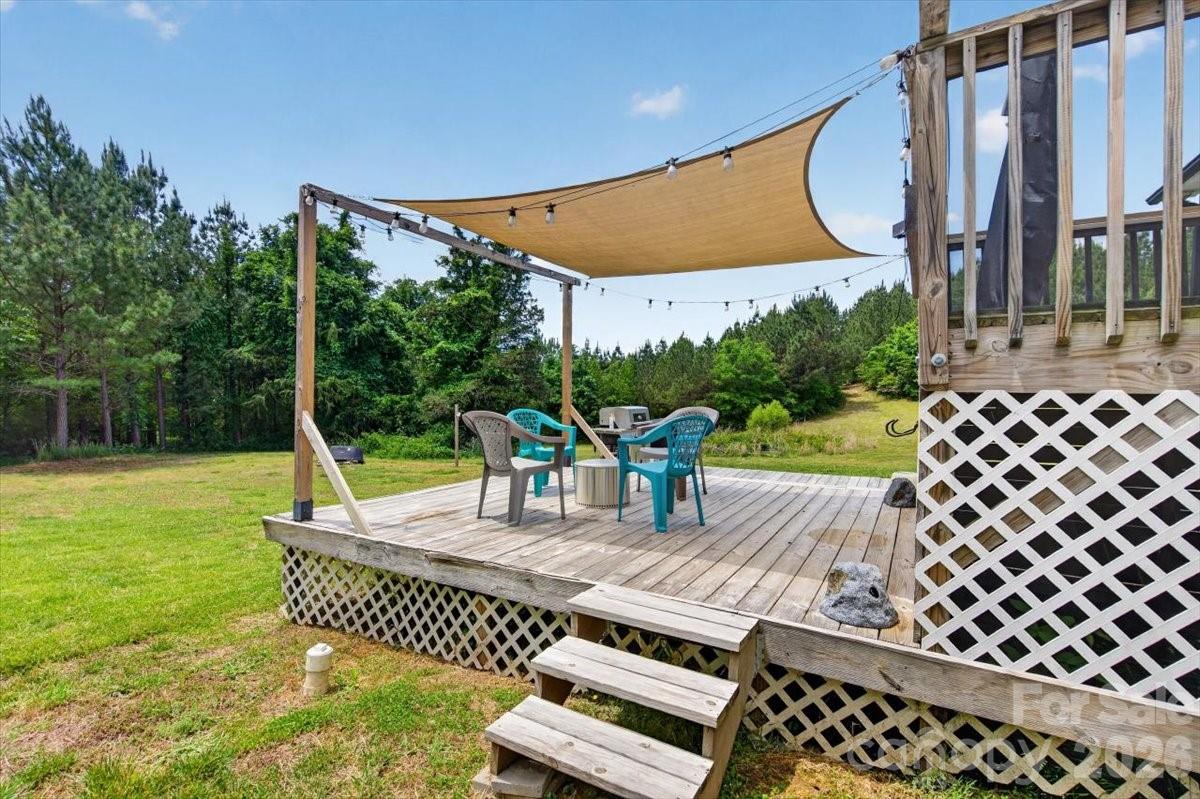 567 Godbey Road Mocksville, NC 27028 - Photo 23 of 38 a view of a patio with a table chairs and a garden