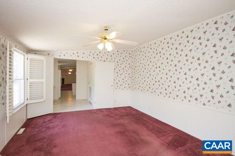 18 Tabscott Road Kents Store, VA 23084 - Photo 15 of 46 an empty room with a chandelier fan and windows