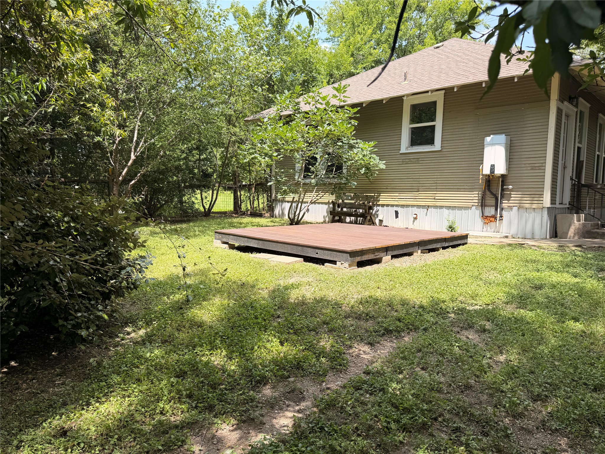1136 Eleanor Street Austin, TX 78721 - Photo 24 of 30 A spacious backyard with mature trees and a low-profile deck invites outdoor relaxation.