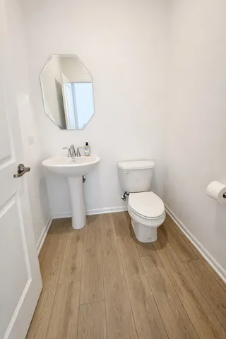 a bathroom with a toilet and a mirror